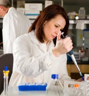 Lab tech working with a pipette.