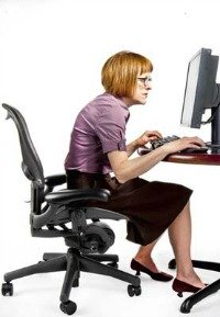 Woman illustrating poor posture at a computer